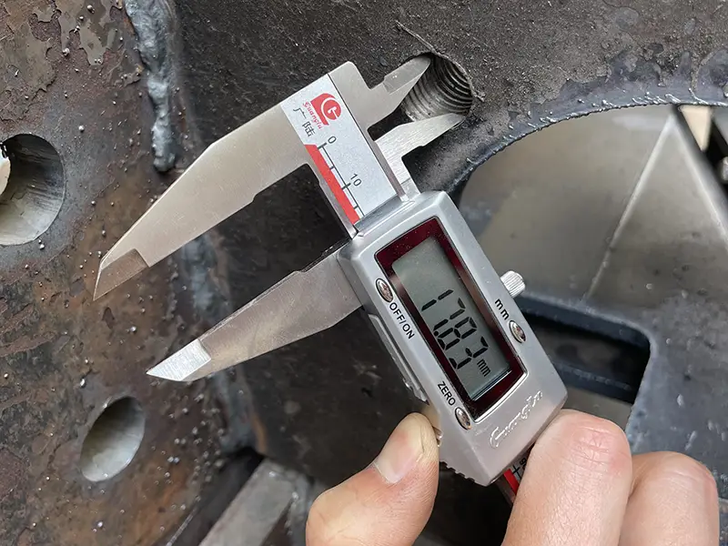 Measuring steel component with caliper